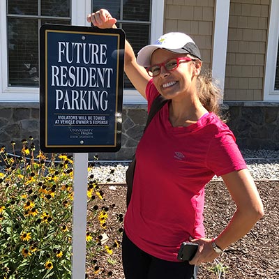 an Avant registered nurse in front of her new apartment building