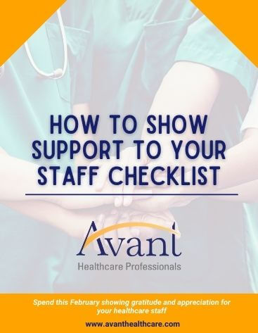A healthcare professional wearing scrubs and a stethoscope supports a patient's hand, emphasizing care and support.