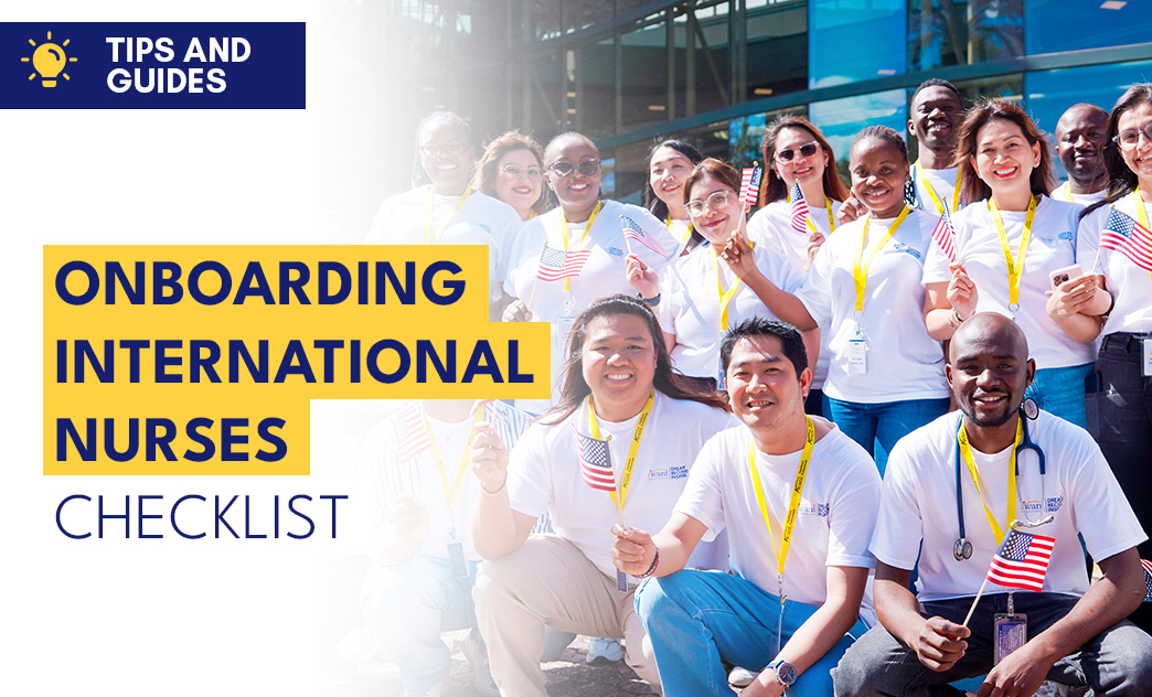 Group of international nurses smiling, holding American flags, outside a modern building for onboarding tips and guides.