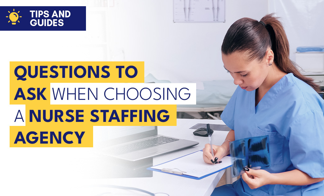 A nurse in scrubs reviews questions on a clipboard and X-ray images, with a laptop nearby, in a clinical setting.