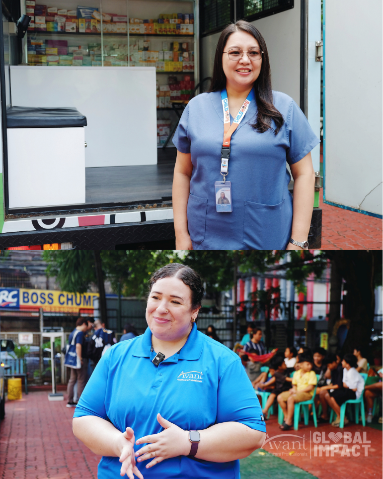 A woman in blue scrubs with an ID badge stands outside a mobile clinic, smiling, with a group of children seated nearby.