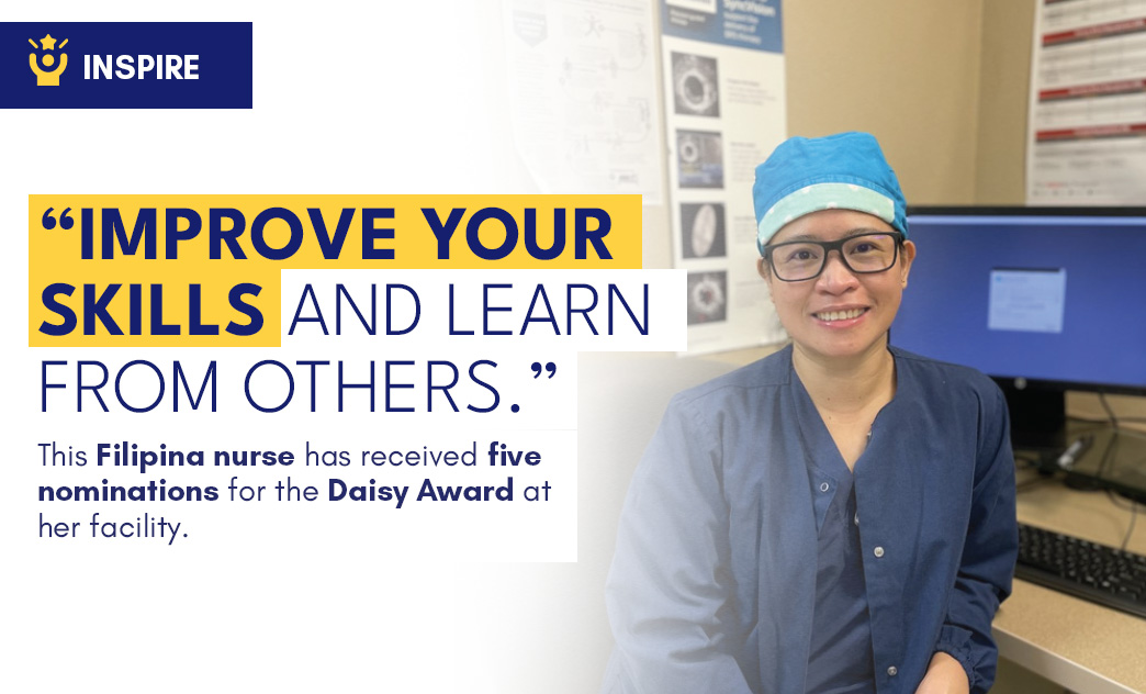 A Filipino nurse wearing glasses and scrubs, smiling in a medical office with posters and a computer in the background.