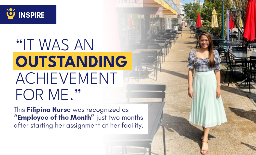 A Filipino nurse stands smiling on a sunny outdoor sidewalk with tables and umbrellas, celebrating her recognition as