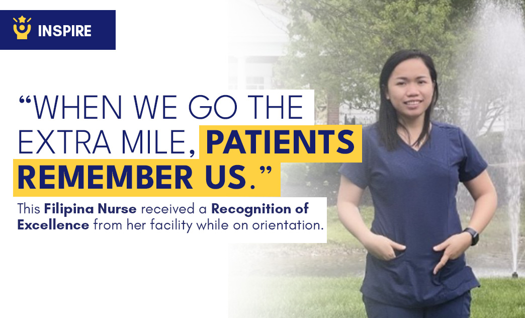 A Filipino nurse in navy scrubs standing outdoors with trees and a fountain in the background.