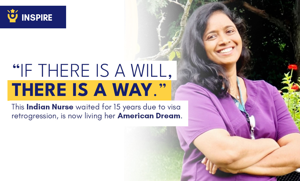 A smiling Indian nurse in purple scrubs stands outdoors with arms crossed, surrounded by greenery and flowers.